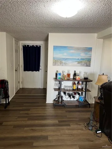 a view of a room with wooden floor