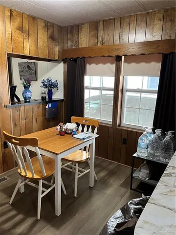 a dining room with furniture a window and a chandelier