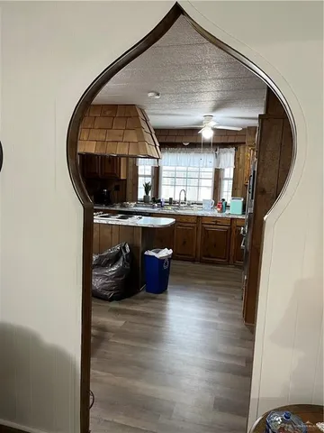 an empty room with wooden floor and outdoor seating