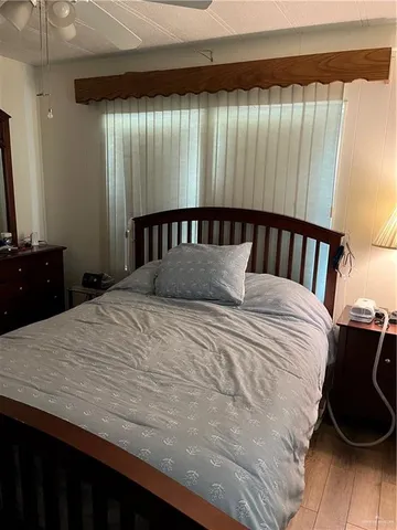 a large bedroom with a bed and a dresser