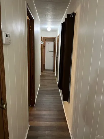 a view of hallway with wooden floor