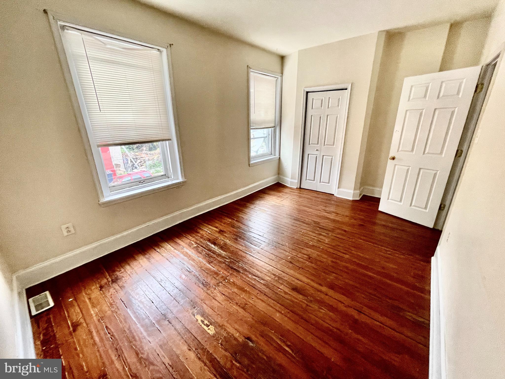 180 Manheim Street, Unit 2 Philadelphia, PA 19144 - Photo 9 of 10 a view of an empty room with wooden floor and a window