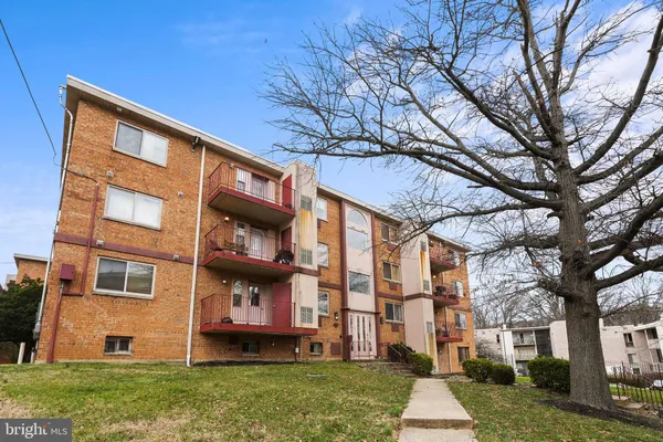 a view of a brick building next to a yard