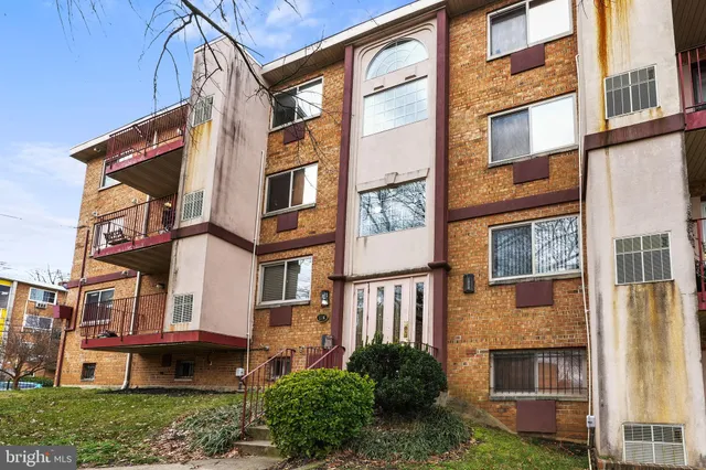 a view of a brick building next to a yard