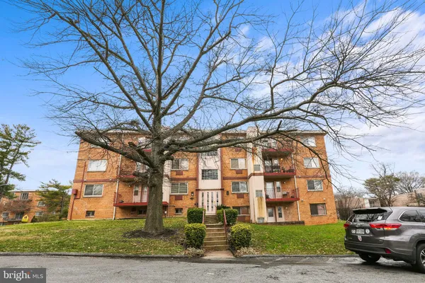 a car parked in front of a brick house