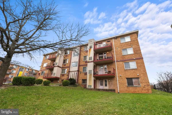 a view of a brick building next to a big yard