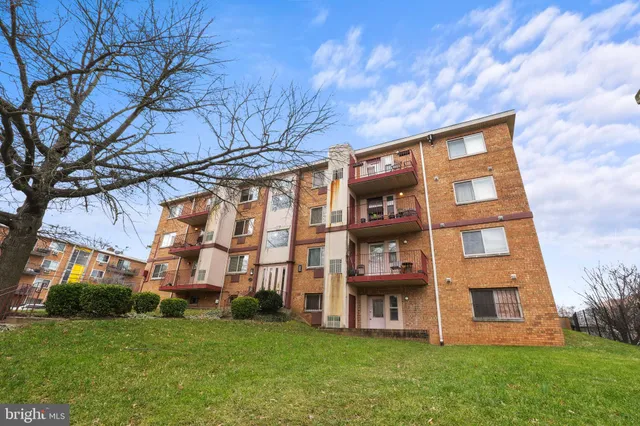 a view of a brick building next to a big yard