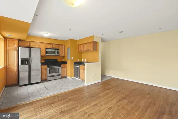 a kitchen with stainless steel appliances a refrigerator and a stove top oven