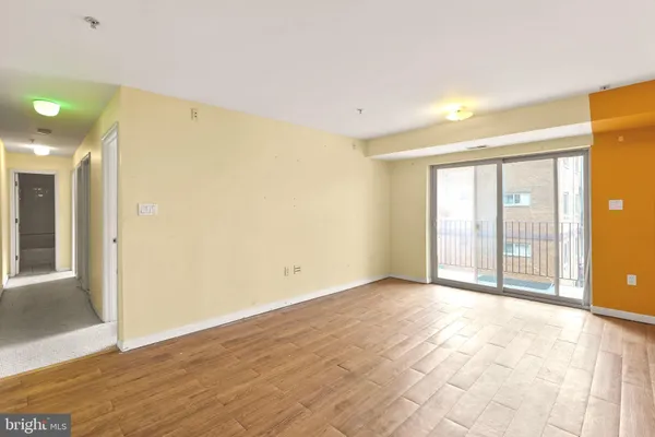 a view of an empty room with glass door