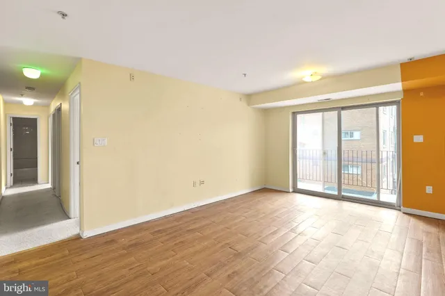 a view of an empty room with glass door