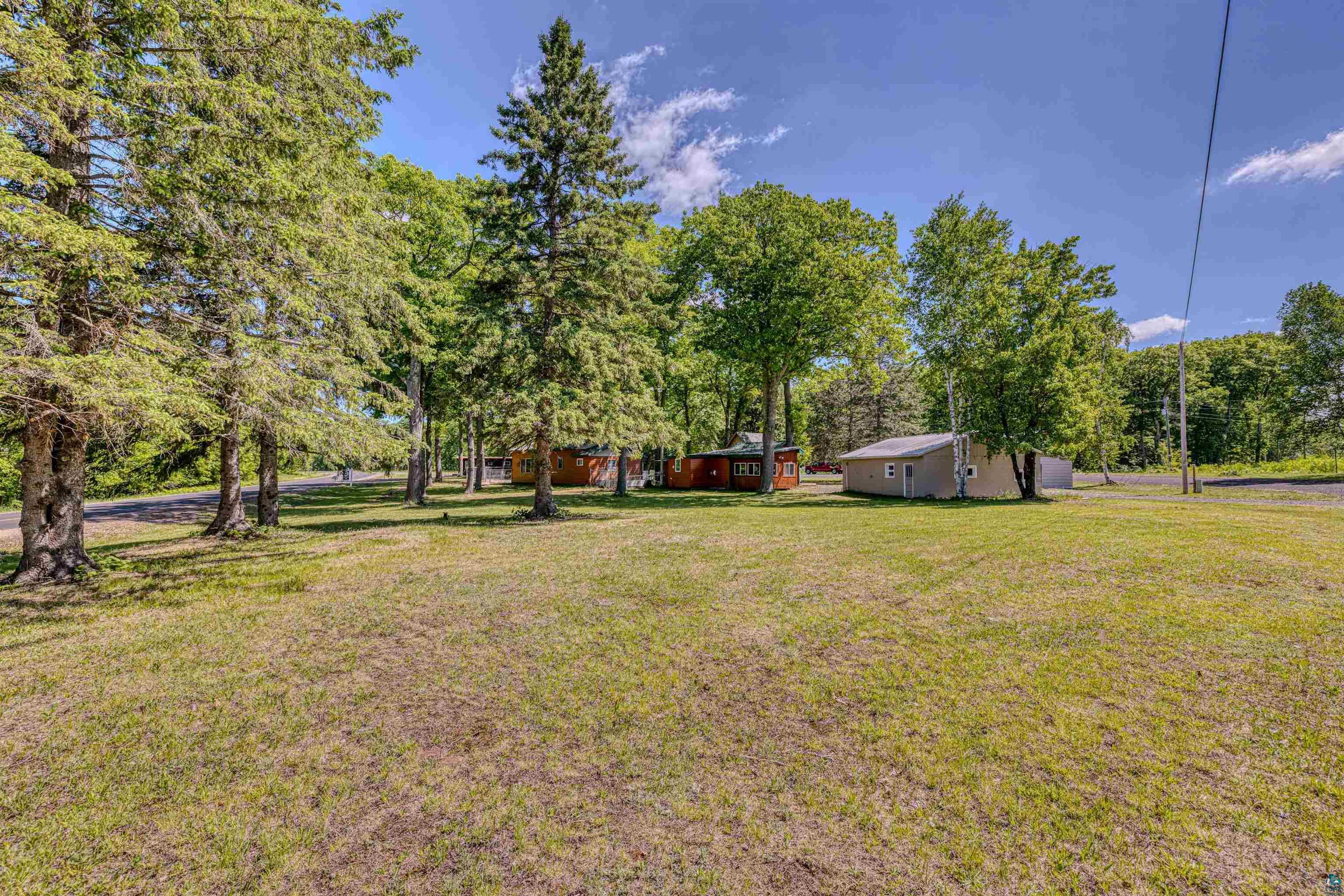 66075 Rooster Road Iron River, WI 54847 - Photo 42 of 52 Expansive grassy area with mature deciduous and evergreen trees