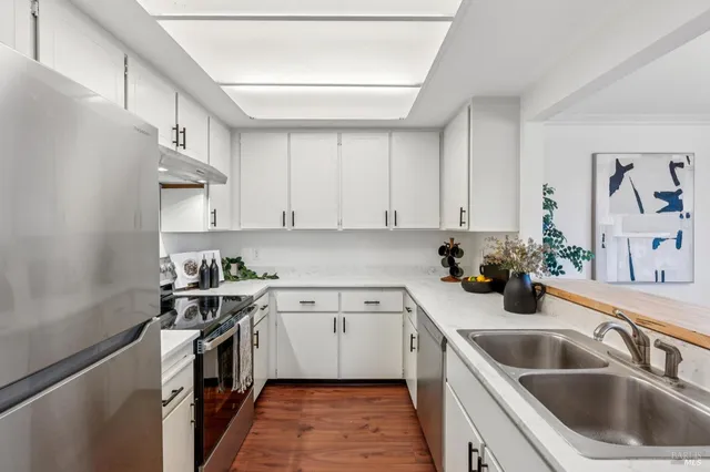 a kitchen with a sink cabinets and stainless steel appliances