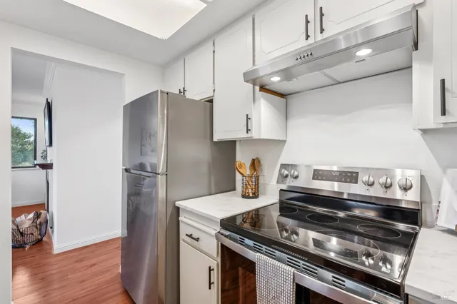 a kitchen with a stove and a refrigerator