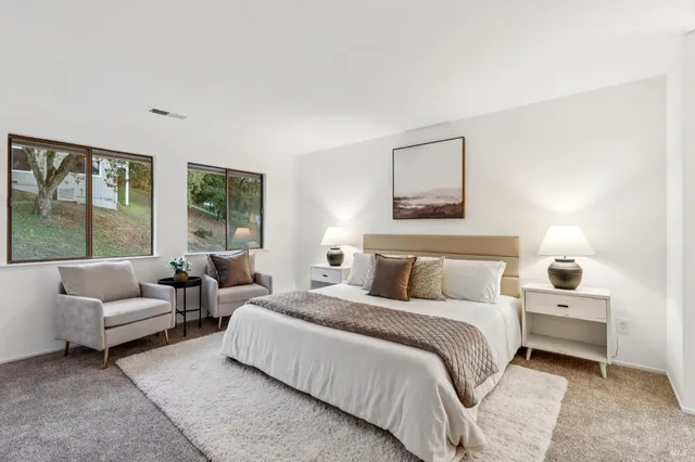 a bedroom with bed and a large window