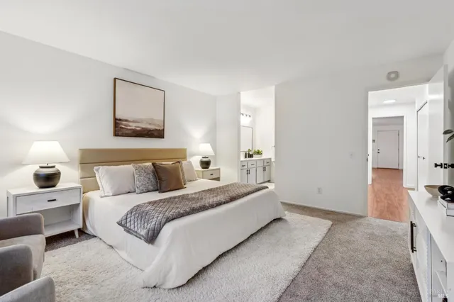 a spacious bedroom with a bed and a couch