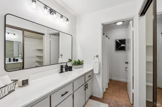 a bathroom with a double vanity sink and mirror