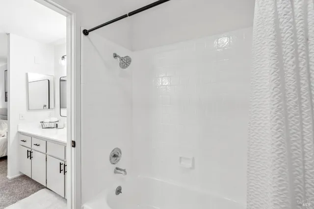 a bathroom with a tub sink and mirror