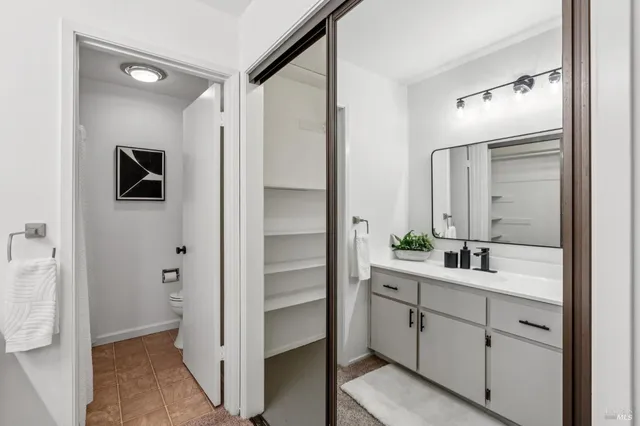a bathroom with a double vanity sink and mirror