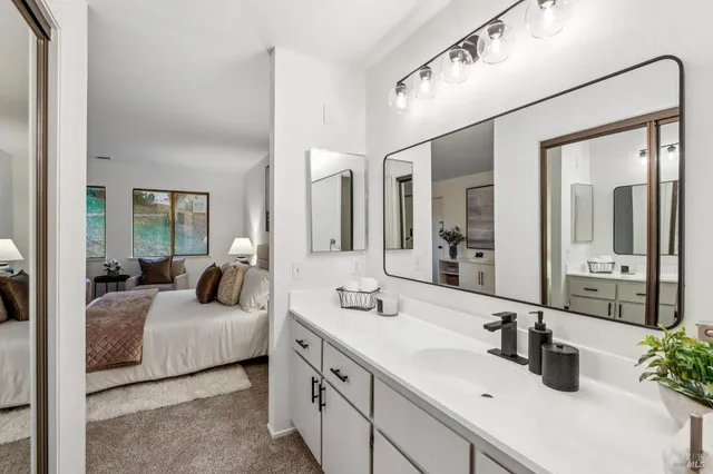 a en suite bathroom with double sink and a mirror