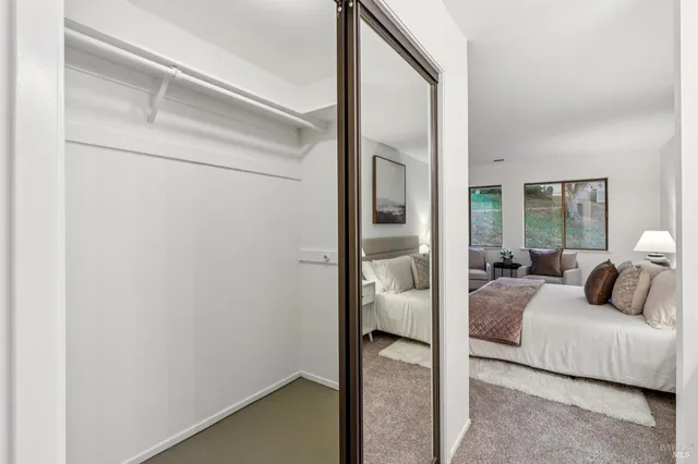 a bedroom with a bed and a mirror