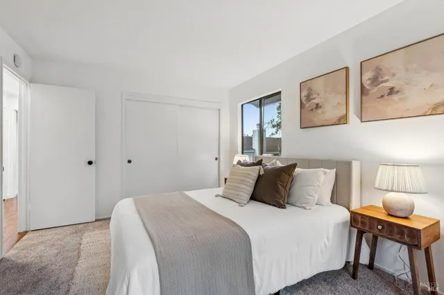 a bedroom with a bed and a lamp on table