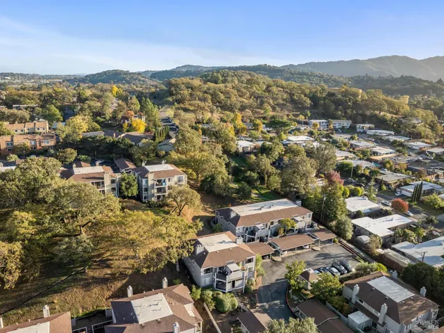 an aerial view of residential building and lake