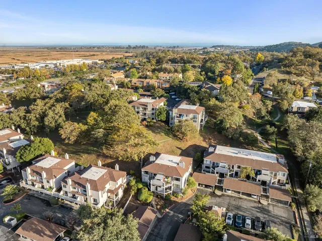an aerial view of residential houses with city view