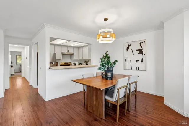 a view of a dining room with furniture and wooden floor