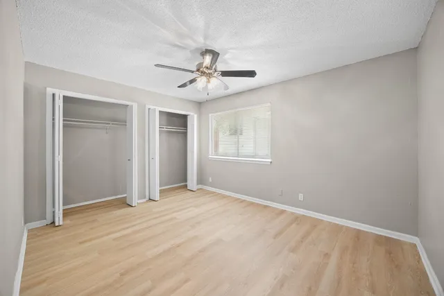 a view of a backyard with wooden fence