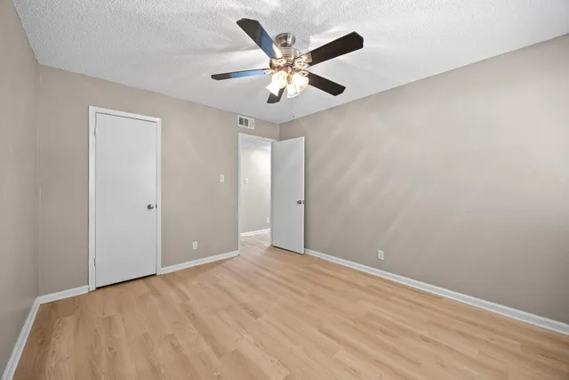 a white toilet sitting next to a bath tub