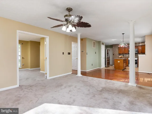 a view of livingroom with kitchen view and a chandelier