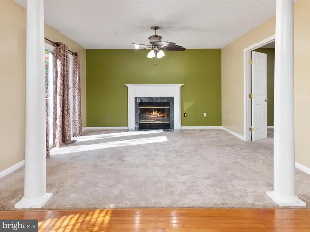 a view of a livingroom with a fireplace a fireplace and chandelier