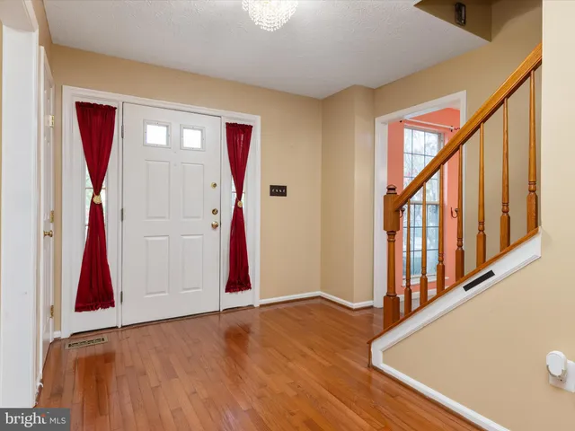 a view of an entryway with wooden floor