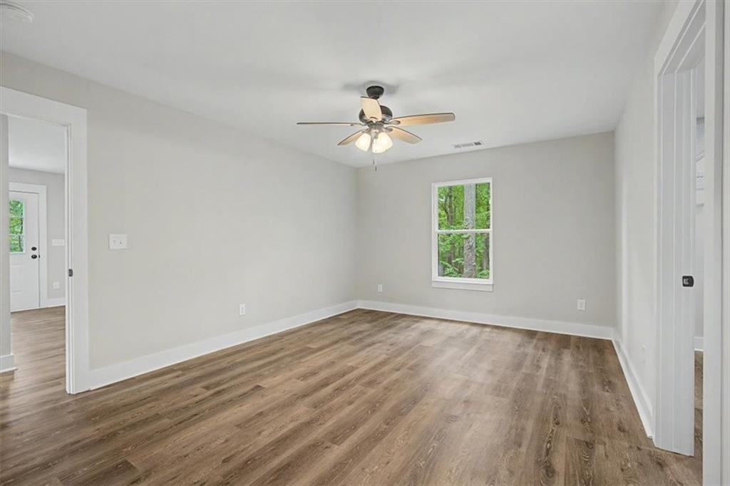 233 Old Old Alabama Road Southeast Emerson, GA 30137 - Photo 20 of 49 a view of empty room with wooden floor and fan
