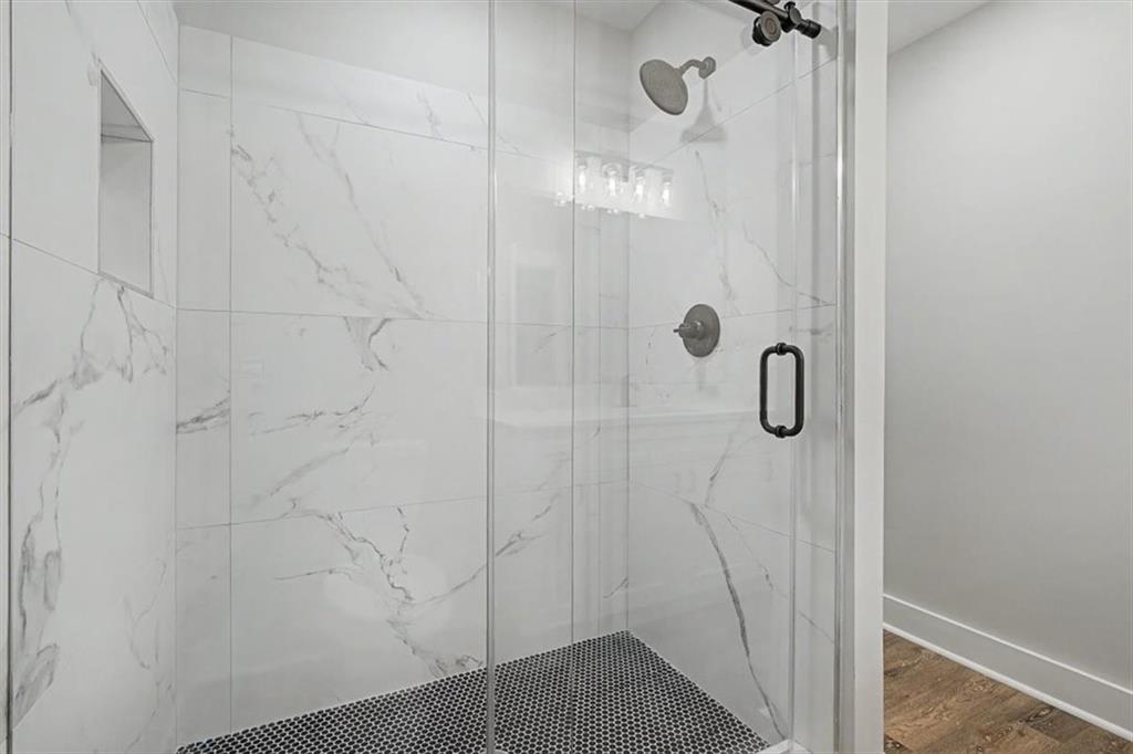 233 Old Old Alabama Road Southeast Emerson, GA 30137 - Photo 24 of 49 a bathroom with a glass shower door