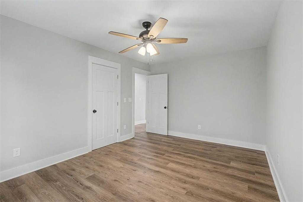233 Old Old Alabama Road Southeast Emerson, GA 30137 - Photo 32 of 49 a view of an empty room with wooden floor and a ceiling fan