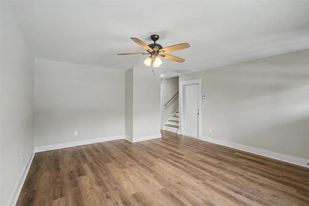 233 Old Old Alabama Road Southeast Emerson, GA 30137 - Photo 9 of 49 a view of a room with a ceiling fan and a hardwood floor