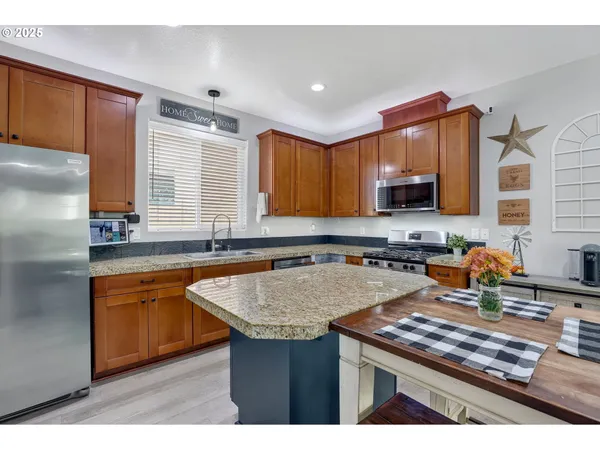 a kitchen with granite countertop a sink stove and cabinets