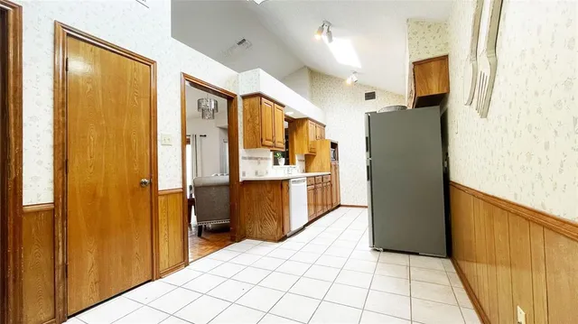 a kitchen with stainless steel appliances a refrigerator and a stove top oven