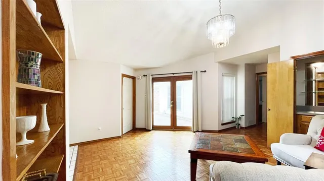 a living room with furniture and a chandelier