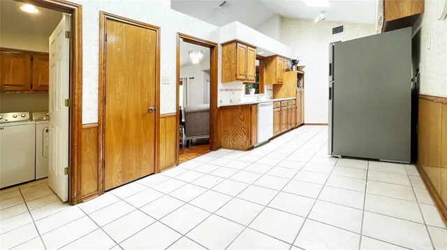 a kitchen with stainless steel appliances a refrigerator and a stove