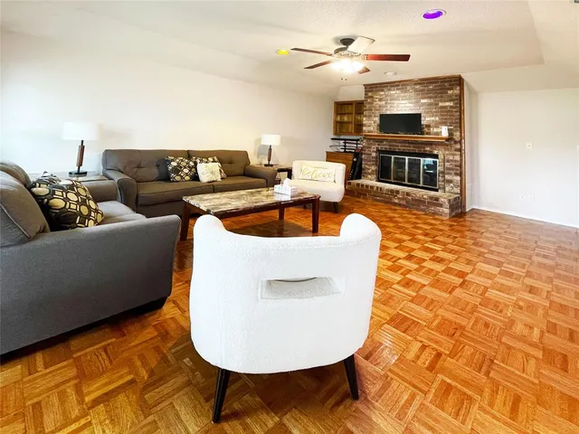 a living room with furniture a fireplace and a flat screen tv