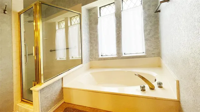 a bathroom with a bathtub and a shower
