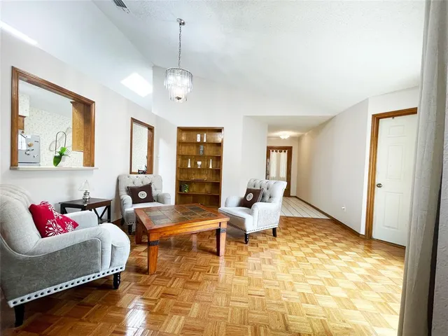 a living room with furniture rug and a window