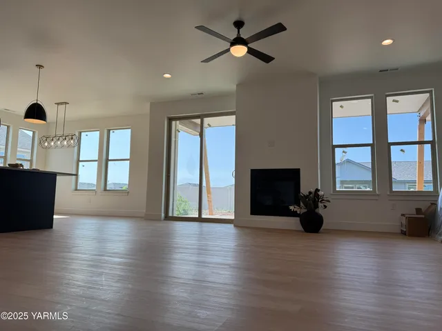 a view of livingroom with hardwood floor and a ceiling fan