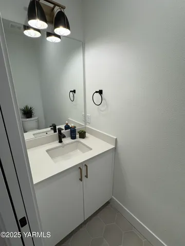 a bathroom with a sink vanity and mirror