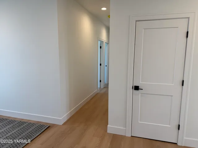 a view of hallway with wooden floor
