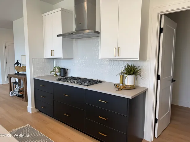 a kitchen with stainless steel appliances granite countertop a refrigerator and a stove