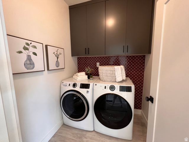 1951 2900 West Provo, UT 84601 - Photo 21 of 21 Dedicated laundry area featuring modern appliances, dark gray upper cabinetry, and a distinctive red scalloped tile backsplash