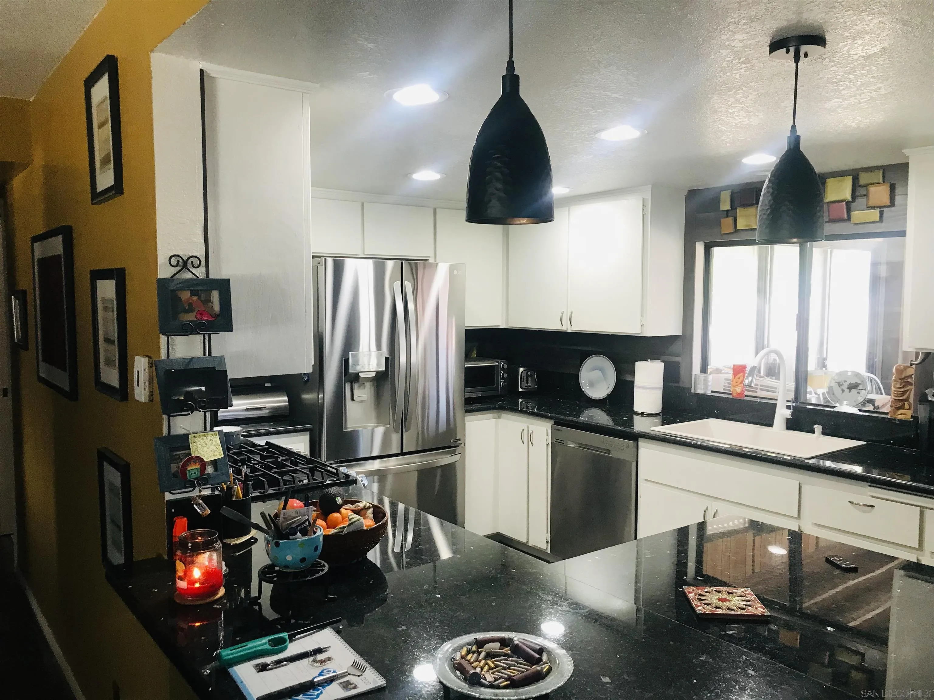 14665 Hopi Road Apple Valley, CA 92307 - Photo 14 of 21 a kitchen with a refrigerator a stove a sink and a cabinets